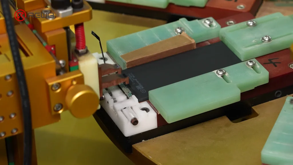 how iphone aftermarket battery bms boards are made Automated spot welding equipment connecting a battery cell to a BMS board held in an assembly fixture